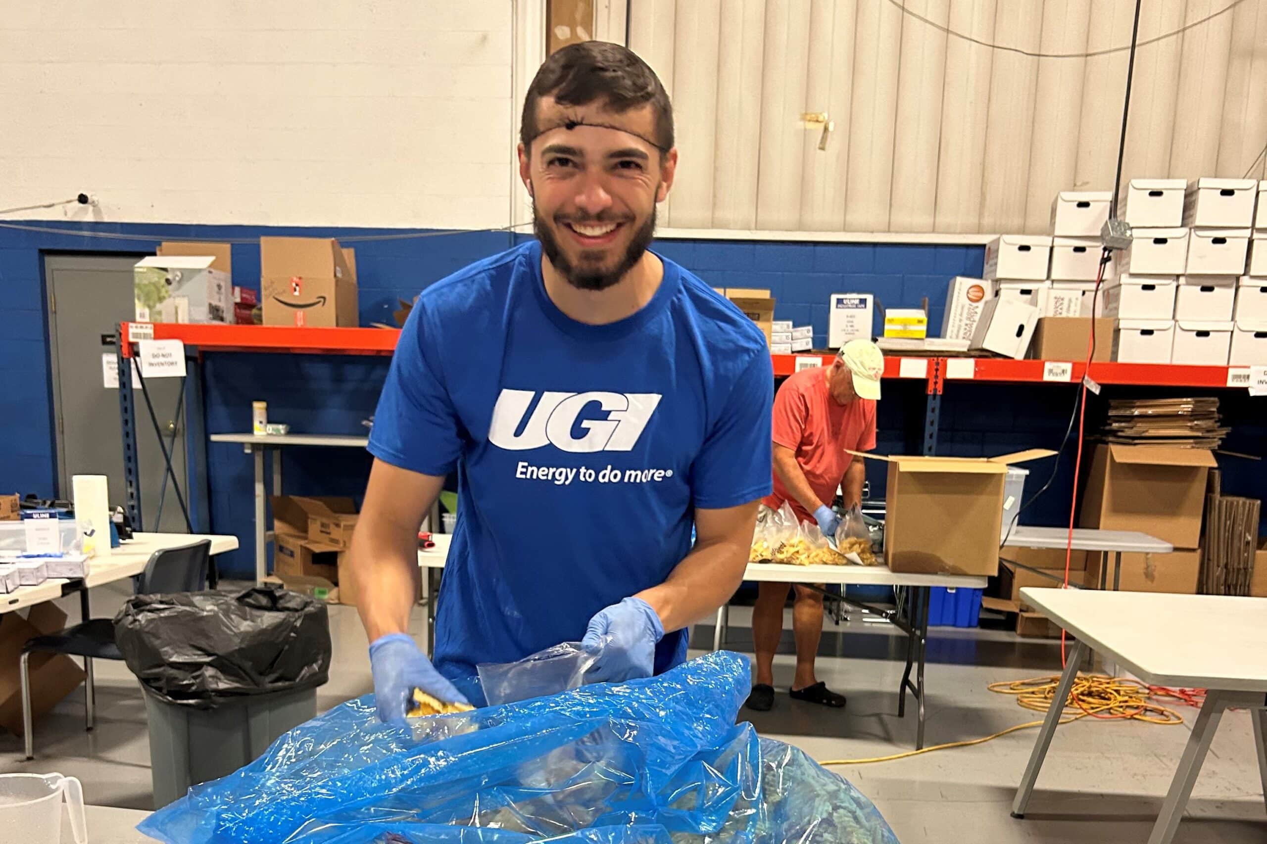 UGI volunteer packing potato chips into individual snack bags