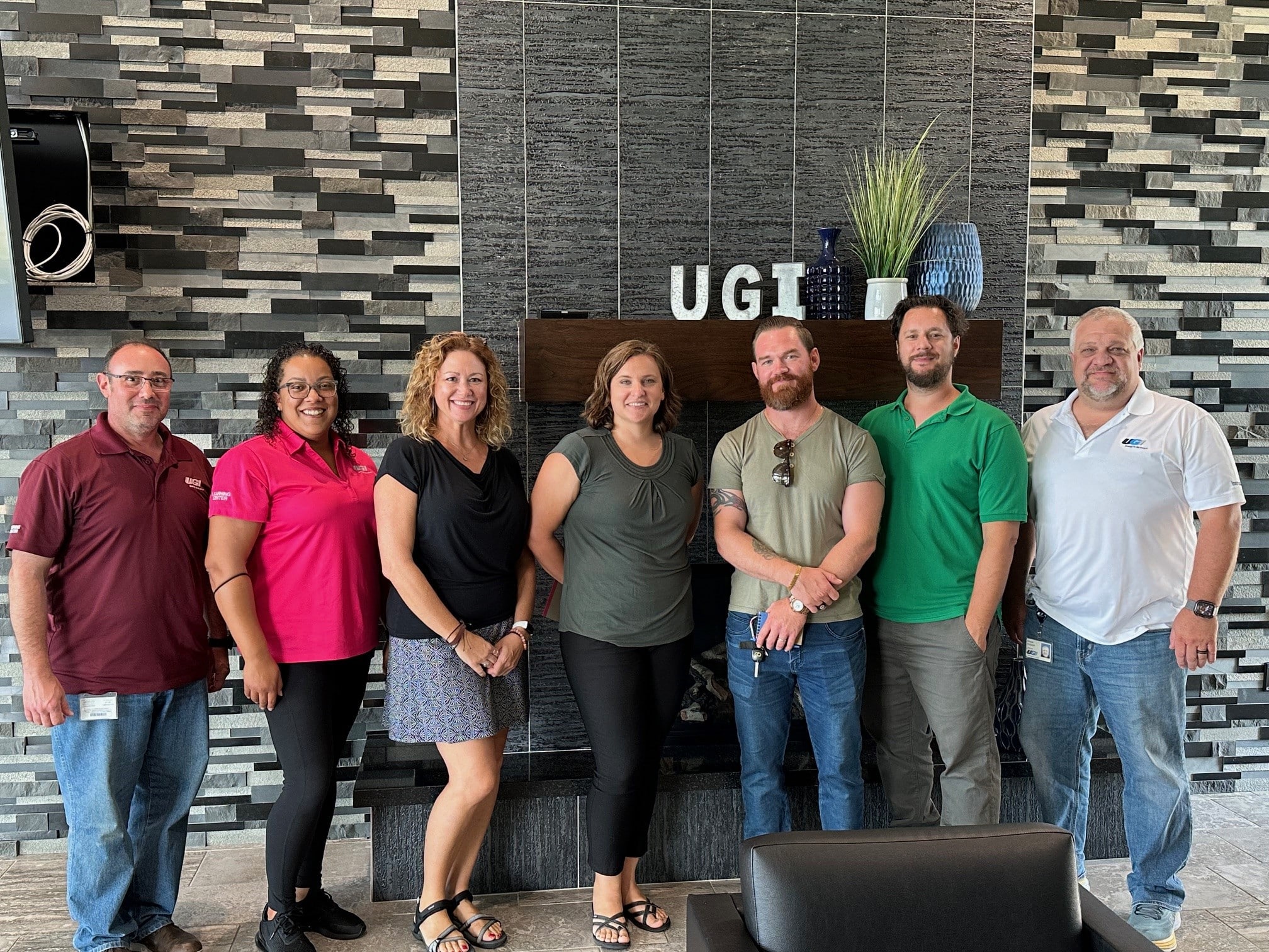 Teachers stand with UGI employees during tour of UGI's Learning Center.